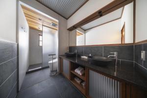 a bathroom with two sinks and a toilet at Powderhouse by The Hakuba Collection in Hakuba +33 photos