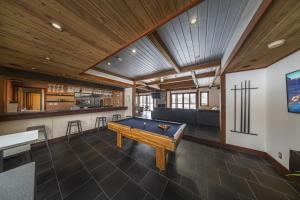 a pool table in the middle of a room at Powderhouse by The Hakuba Collection in Hakuba