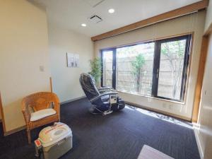 a waiting room with a chair and a window at Hotel Route-Inn Nagaoka Inter in Nagaoka +27 photos