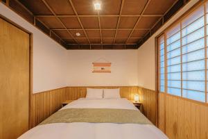 a small bedroom with a bed and a window at 如意二条城Ruyi Nijojo in Kyoto