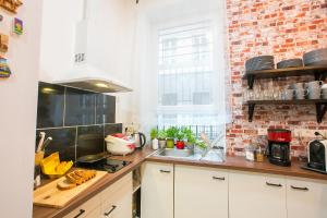 a kitchen with a stove top oven and a window at Friends Hostel & Apartments in Budapest