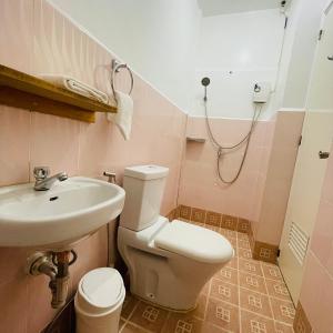 a bathroom with a toilet and a sink at Castle Rock Boracay in Boracay +16 photos