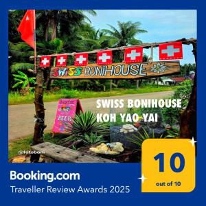 a sign for aoss bourn house with a flag at Swiss Bonihouse Koh Yao Yai in Ban Phlu Nai