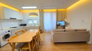 a kitchen and dining room with a table and a couch at A-Bridge house 2-A in Incheon