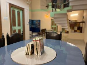 a group of books sitting on a table at The Noor House homestay in Agra
