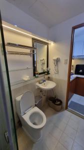 a bathroom with a toilet and a sink at The Villa Staycation at La Verti Residences in Manila