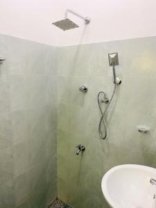 a bathroom with a shower and a sink at Stille Oase Inn in Matara +57 photos