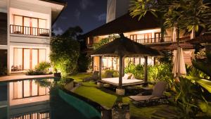 a villa with a swimming pool and a gazebo at Villa Diana Bali 14 Bedrooms in Seminyak