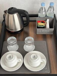 a tray with two plates and a tea pot on it at BMG Hotel by Grigoryans Group in Goris +66 photos