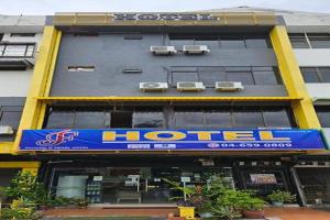 a hotel with a blue sign on the side of a building at F Hotel Bayan Lepas in Bayan Lepas