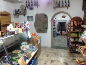 a grocery store with a counter with food and a store sidx sidx sidx at B&B L'Alba in Gagliato