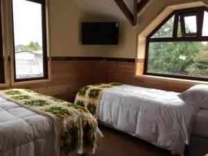 Katil atau katil-katil dalam bilik di Cabañas Estacion del Lago