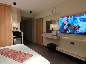 a hotel room with a large flat screen tv on the wall at Zamzam Hotel 1 in An Najaf