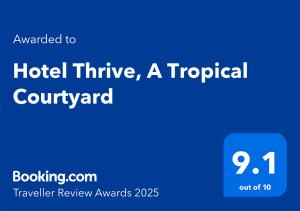 un cartello blu con le parole "iniziativa hotel" un tropicalcourtland di Hotel Thrive, A Tropical Courtyard a Kathmandu