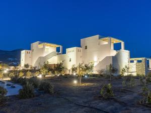 a large white building at night at Plioni Villas With Private Pool & Suites With Hot Tub in Mikri Vigla