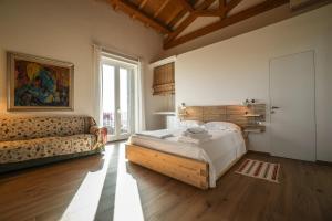 a bedroom with a large bed and a couch at Contrada Salice in Milo +106 photos