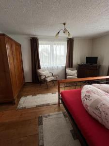 a bedroom with a bed and a living room at Behagliches Haus mit Kamin Bayerischer Wald in Tiefenbach