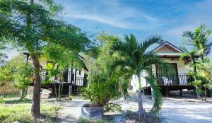 a house with palm trees in front of it at TinyHouse at TigerCave in Ko Bu Bu +40 photos