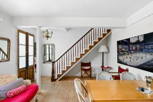 a living room with a dining table and a staircase at metro hotel and Cafe in Petaluma