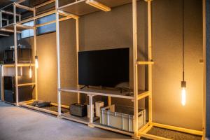 a room with a flat screen tv on a shelf at Mi-Kan Design Hotel in Tokyo