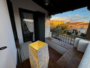 Habitación con vistas a un balcón con mesa y ventana. en Sardegna Porto San Paolo, en Porto San Paolo