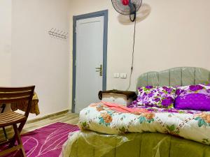 a bedroom with a bed with colorful pillows at Room for rent - downtown in Cairo