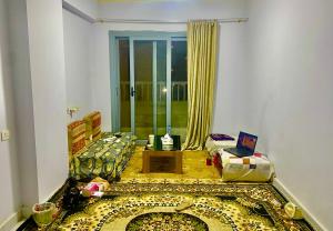a living room with a couch and a laptop on a table at Room for rent - downtown in Cairo