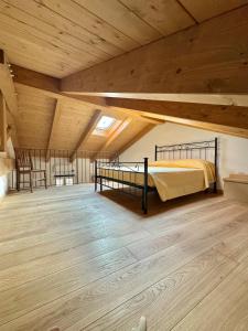 a large room with a bed and a wooden ceiling at La piccola Maison in Mondovì +6 photos