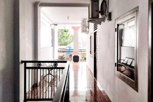 a hallway with a staircase in a house at RedDoorz at Amanah Syariah Residence Tanjung Karang Lampung in Tanjungkarang