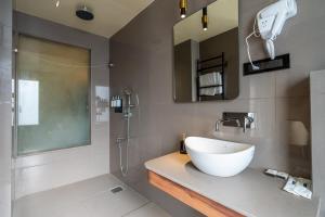 a bathroom with a sink and a shower at The White Rock Inn & Dine in Shillong +41 photos