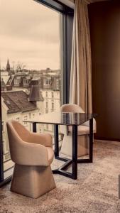 a room with a table and two chairs and a window at Bellman Hotel in Berlin