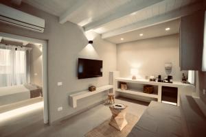 a living room with a tv on the wall at Palermo Inn Boutique Arte in Palermo