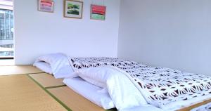 Postel nebo postele na pokoji v ubytování Hotel KAZENOIRO
