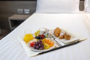 a tray of breakfast food on a bed at Just Hotel Saronno in Saronno