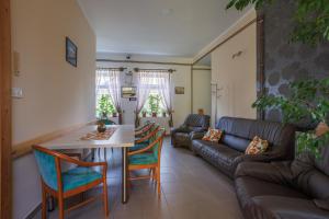 a living room with a couch and a table at Harang Panzió in Gyomaendrőd