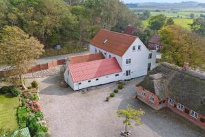 an aerial view of a white building with a red roof at Large Holiday Home By The Limfjord in Thyholm