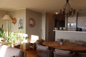 a kitchen and dining room with a table and chairs at Zonnig appartement met open zicht in Knokke-Heist