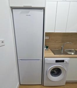 a white refrigerator in a kitchen with a washing machine at Anna Home in Telde +10 photos