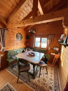 a dining room with a table and chairs in a cabin at Blockhaus Holzzeit im Bayerischen Wald in Stamsried