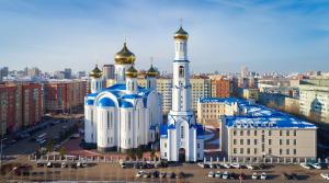 a large building with a mosque in a city at 3х комнатная квартира в Астане in Astana