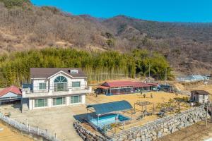 an aerial view of a house with a golf course at Okcheon Saebom Group Pension in Okcheon