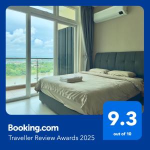 a bedroom with a bed and a large window at Blue Cove Riverine Diamond Kuching in Kuching
