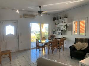 a living room with a table and chairs at Villa Mike's House in Apolpaina