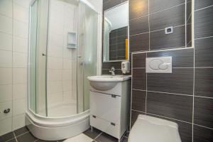 a bathroom with a toilet and a sink and a shower at Villa Tucepi Beach in Tučepi +115 photos