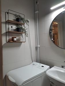 a white bathroom with a sink and a mirror at Tilava kolmio keskustassa in Ylivieska +7 photos