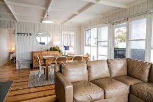 a living room with a couch and a table at Metung Holiday House in Metung