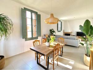 a dining room with a wooden table and chairs at Mas Nadal Montseny in Sant Esteve de Palautordera +14 photos