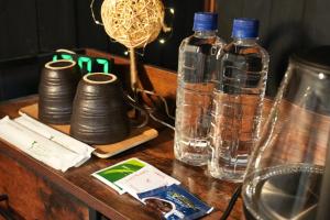 a wooden table with two bottles of water on it at SYMPOSION Locanda in Kamakura