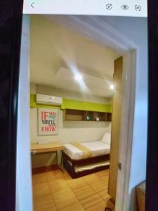 a room with a bed and a sign that reads if you wont karma at One Oasis 2br Condo in Davao City