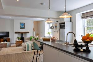 a kitchen and living room with a counter top at Finest Retreats - The Old Estate Office Nr Grantley Hall in Grantley +17 photos
